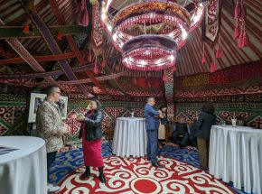 At a reception at the residence of U.S. Ambassador David Rosenblum in Astana, American artist Ángel Rafael Vázquez-Concepción talks with assembled guests including Kazakh artist and activist Karipbek Kuyukov.
